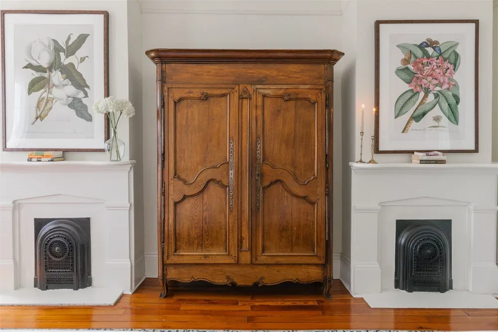 Wedding dress hanging from an antique armoire