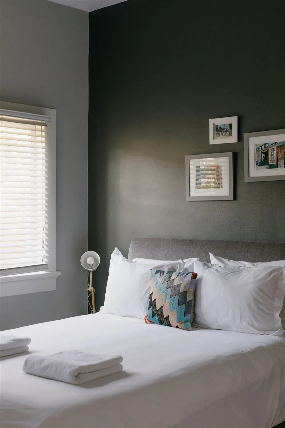 Dark bedroom with bed and bedside lamp