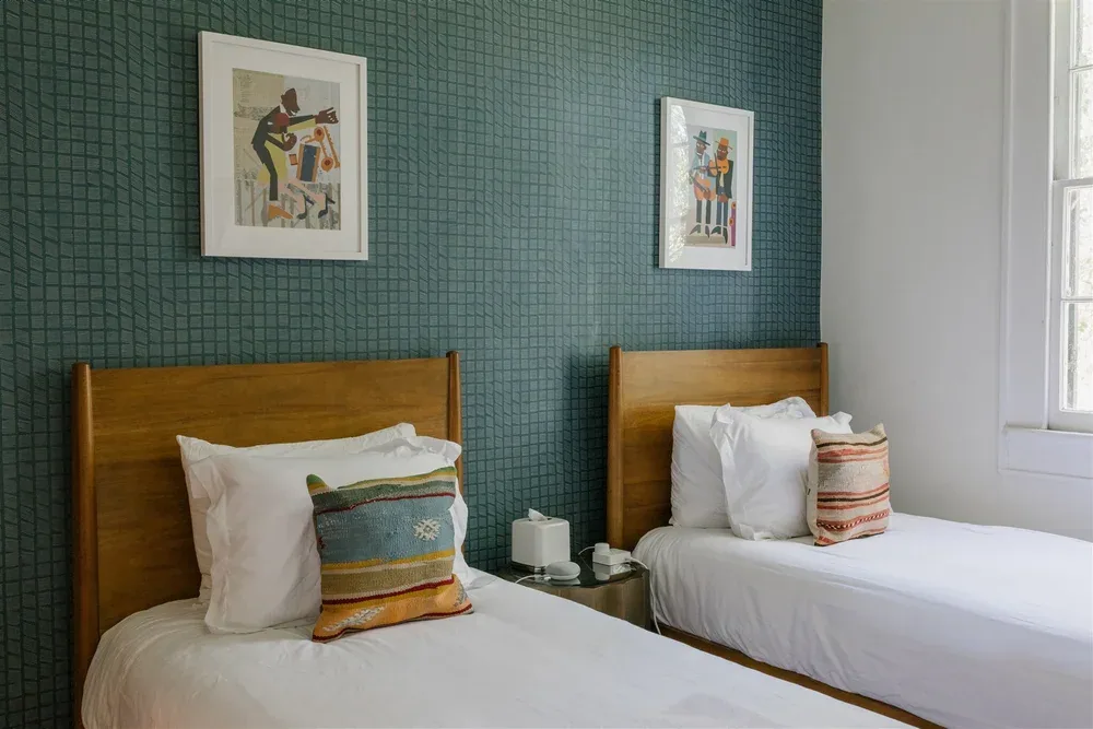 Bedroom with blue wall and white bedding